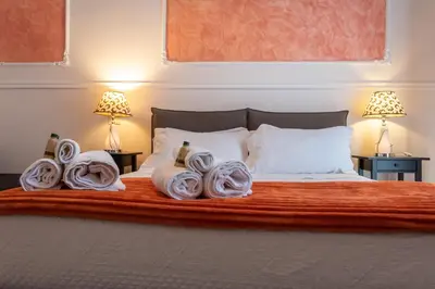 a bedroom with a bed with towels on it at Liberty Palace in Palermo