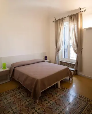 a bedroom with a large bed and a window at Rooms 19 B&B in Palermo