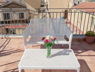a vase of flowers sitting on a table on a balcony at Rooms 19 B&B in Palermo