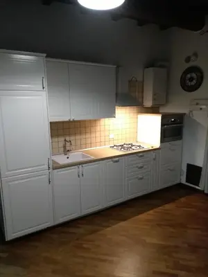 a kitchen with white cabinets and a sink and a refrigerator at Casa PAN (Percorso Arabo Normanno) in Palermo