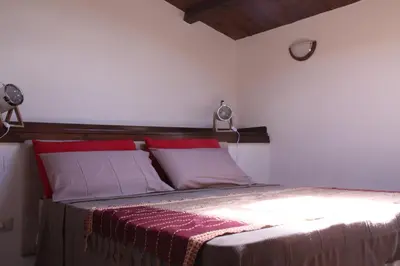a bedroom with a bed with red and white pillows at Casa PAN (Percorso Arabo Normanno) in Palermo