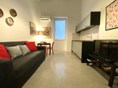 a living room with a couch and a television at Da Nelly al Politeama in Palermo