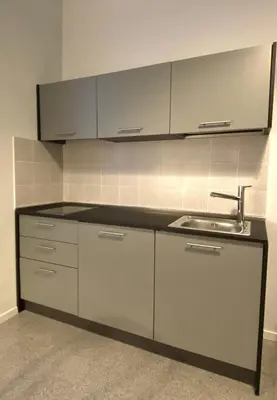a kitchen with white cabinets and a sink at Da Nelly al Politeama in Palermo