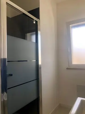 a glass shower in a bathroom with a sink at Alcamo Marina Residence in Alcamo Marina
