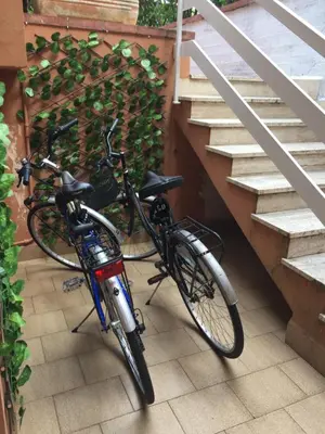 two bikes are parked next to some stairs at George House Mondello 34 in Mondello
