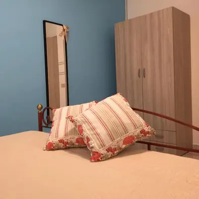 a bedroom with a bed with two pillows on it at George House Mondello 34 in Mondello