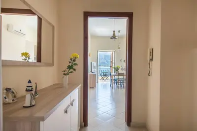 a kitchen with a view of a dining room at Casetta Vista Mare in Piazza a Mondello by Wonderful Italy in Palermo