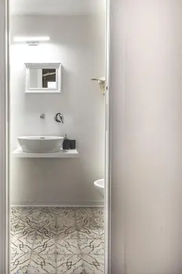 a white bathroom with a sink and a toilet at Stylish Home in Front of Casa Professa by Wonderful Italy in Palermo
