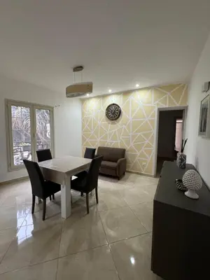 a living room with a table and chairs and a couch at Apartment Rua Formaggi in Palermo