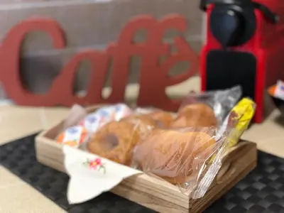 a wooden box of donuts sitting on a table at Apartment Rua Formaggi in Palermo