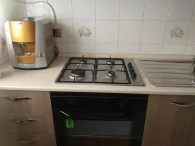 a kitchen with a stove and a coffee maker at Giusy's Place 1 in Campofelice di Roccella