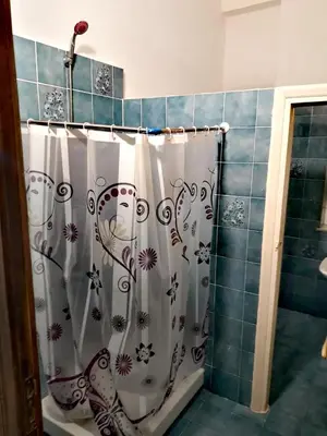 a bathroom with a shower with a shower curtain at Arco di ballarò in Palermo