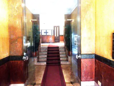 a hallway with a long red carpet in a building at Arco di ballarò in Palermo