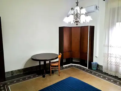 a dining room with a table and a chandelier at Arco di ballarò in Palermo