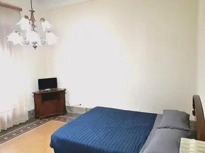 a bedroom with a bed and a table and a window at Arco di ballarò in Palermo
