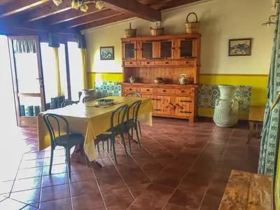 a dining room with a table and some chairs at VILLA VENERE con vista sul mare in San Vito lo Capo