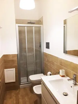 a bathroom with a toilet and a sink at Casa Vacanze Mondello Mare Piscina ALBAMAOR in Mondello