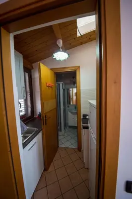 a kitchen with a door open to a kitchen with a sink at 'A Cumerdia - Casa Vacanze in Castellammare del Golfo