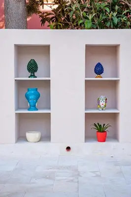 a shelf with three vases sitting on it at Baglio La Riserva in Scopello