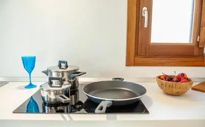 a frying pan on top of a stove in a kitchen at Baglio La Riserva in Scopello