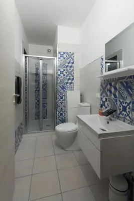a bathroom with a toilet and a sink and a shower at Casa Leonardo e Romeo in Castellammare del Golfo
