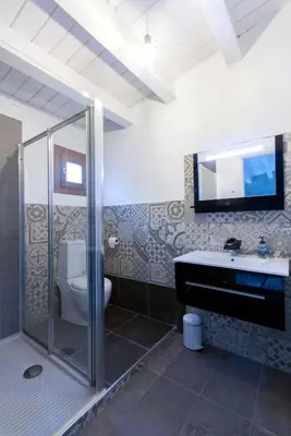 a bathroom with a shower and a toilet and a sink at Casa Leonardo e Romeo in Castellammare del Golfo