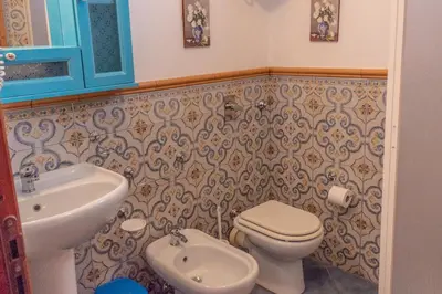 a bathroom with a toilet and a sink at Villa Azzurra con vista sul mare in San Vito lo Capo