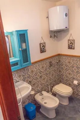 a bathroom with a toilet and a sink at Villa Azzurra con vista sul mare in San Vito lo Capo