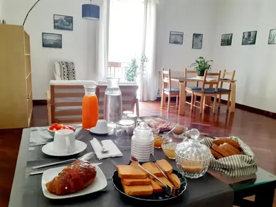 a table with breakfast foods and orange juice on it at B&B Bandiera 77 in Palermo