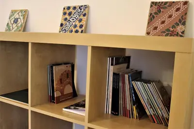 a book shelf filled with books and other books at B&B Bandiera 77 in Palermo