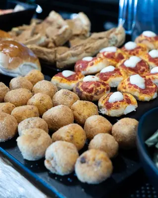 a tray of donuts and pastries on a table at Hotel Pontemare in Palermo