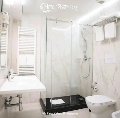 a bathroom with a shower and a sink and a toilet at Hotel Pontemare in Palermo