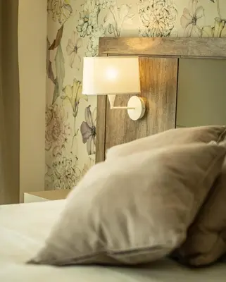 a bed with a lamp and a pillow at Hotel Pontemare in Palermo