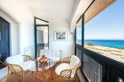 a balcony with a table and chairs and the ocean at Casa con Terrazza sul Mare all'Addaura by Wonderful Italy in Palermo