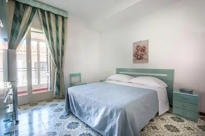 a bedroom with a bed and a large window at Casa con Terrazza sul Mare all'Addaura by Wonderful Italy in Palermo