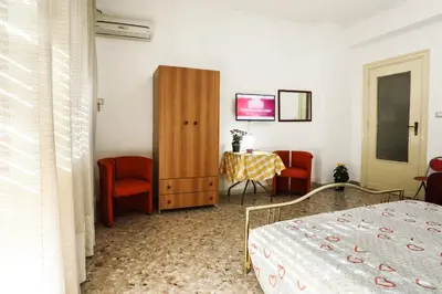 a bedroom with a bed and a table and chairs at A Casa di Fra' in Palermo