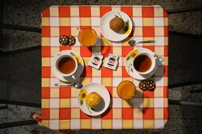a table with plates of food and cups of coffee at A Casa di Fra' in Palermo