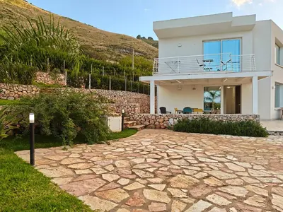 a house with a stone driveway in front of it at Villa Vitruvio - Giardino degli Allori Scopello in Castellammare del Golfo