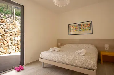 a bedroom with a bed with two towels on it at Villa Vitruvio - Giardino degli Allori Scopello in Castellammare del Golfo