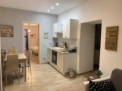 a kitchen and living room with a table and a dining room at IL PANARO in Palermo