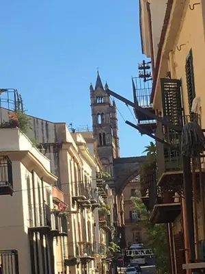 a city street with a clock tower in the background at IL PANARO in Palermo