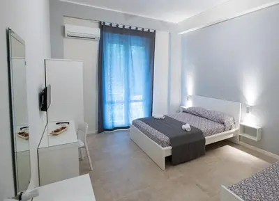 a small bedroom with a bed and a window at Le Stanze Dell'Emiro in Palermo