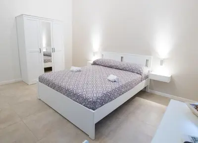 a bedroom with a bed with two towels on it at Le Stanze Dell'Emiro in Palermo