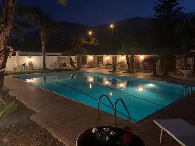 a swimming pool at night with lights at Casa vacanze Villa Grace in Villagrazia