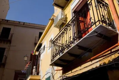 a building with a balcony and a balcony at Teatro Massimo Apartment- SELF CHECK-IN in Palermo