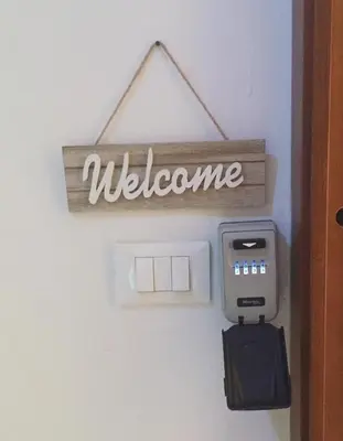 a welcome sign on a door with a mailbox at Teatro Massimo Apartment- SELF CHECK-IN in Palermo