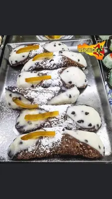 a bunch of bananas on a pan with powdered sugar at Aspra al delfino blu in Bagheria
