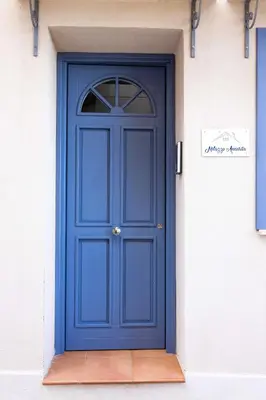 a blue door on the side of a building at Appartamenti centro storico Milazzo Annarita in Castellammare del Golfo