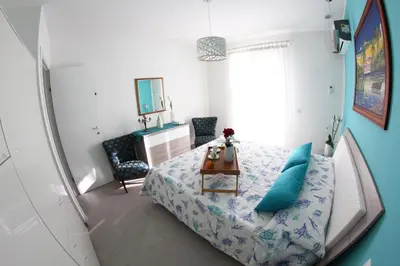 a small bedroom with a bed and a table at APPARTAMENTO L'AIRONE in Balestrate