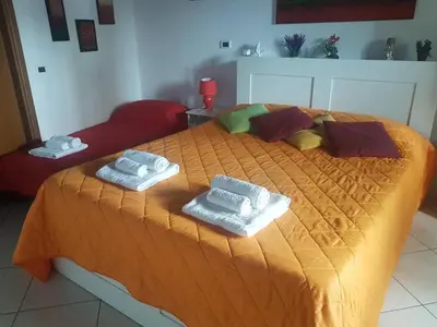 a bedroom with a bed with towels on it at La casetta di Sara in Palermo